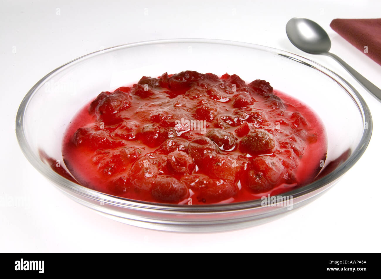 jam of red CRANBERRIES berries on white background in glass plate bowl Vaccinium vitis cranberry idaea FRUIT cran food nice deli Stock Photo