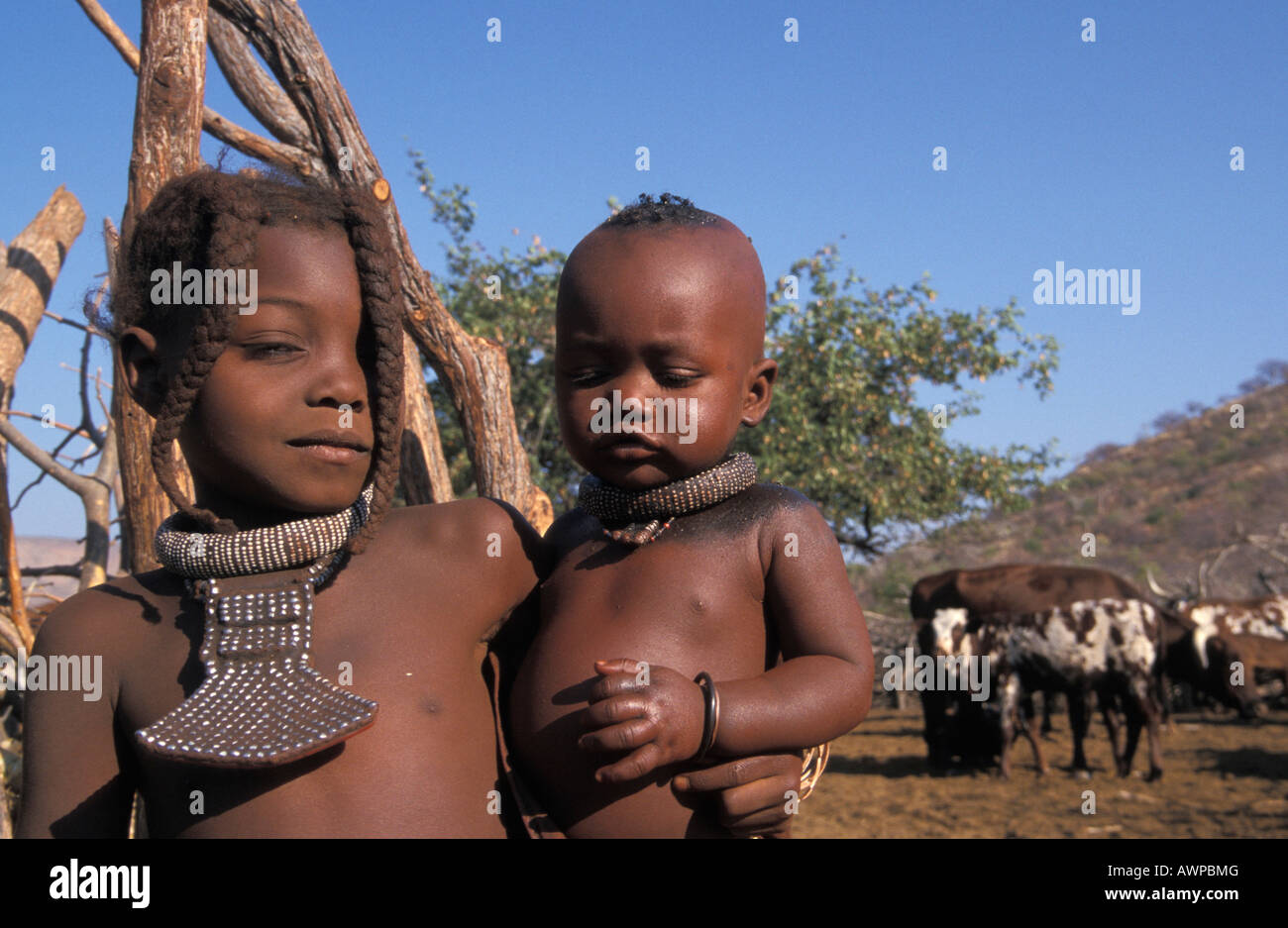 Himba girl with infant, Kaokoveld, Namibia Stock Photo