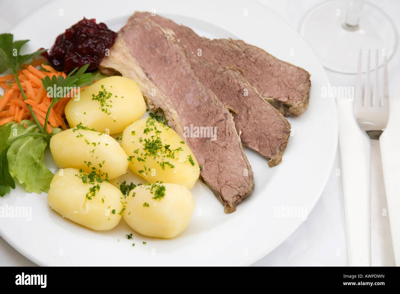 Beef brisket, boiled potato and lingonberry dish Stock Photo