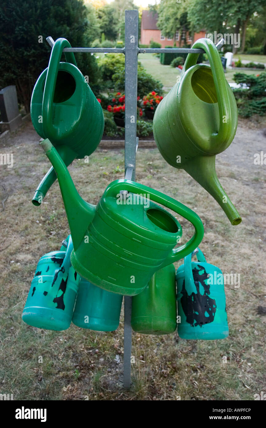 Watering cans at a cemetery Stock Photo