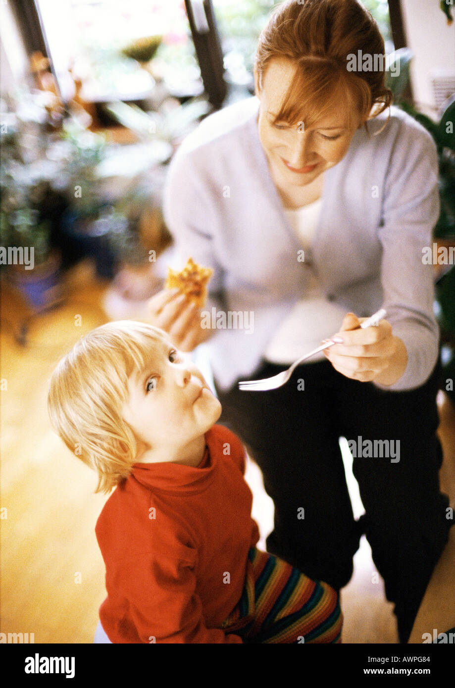 Woman feeding child Stock Photo
