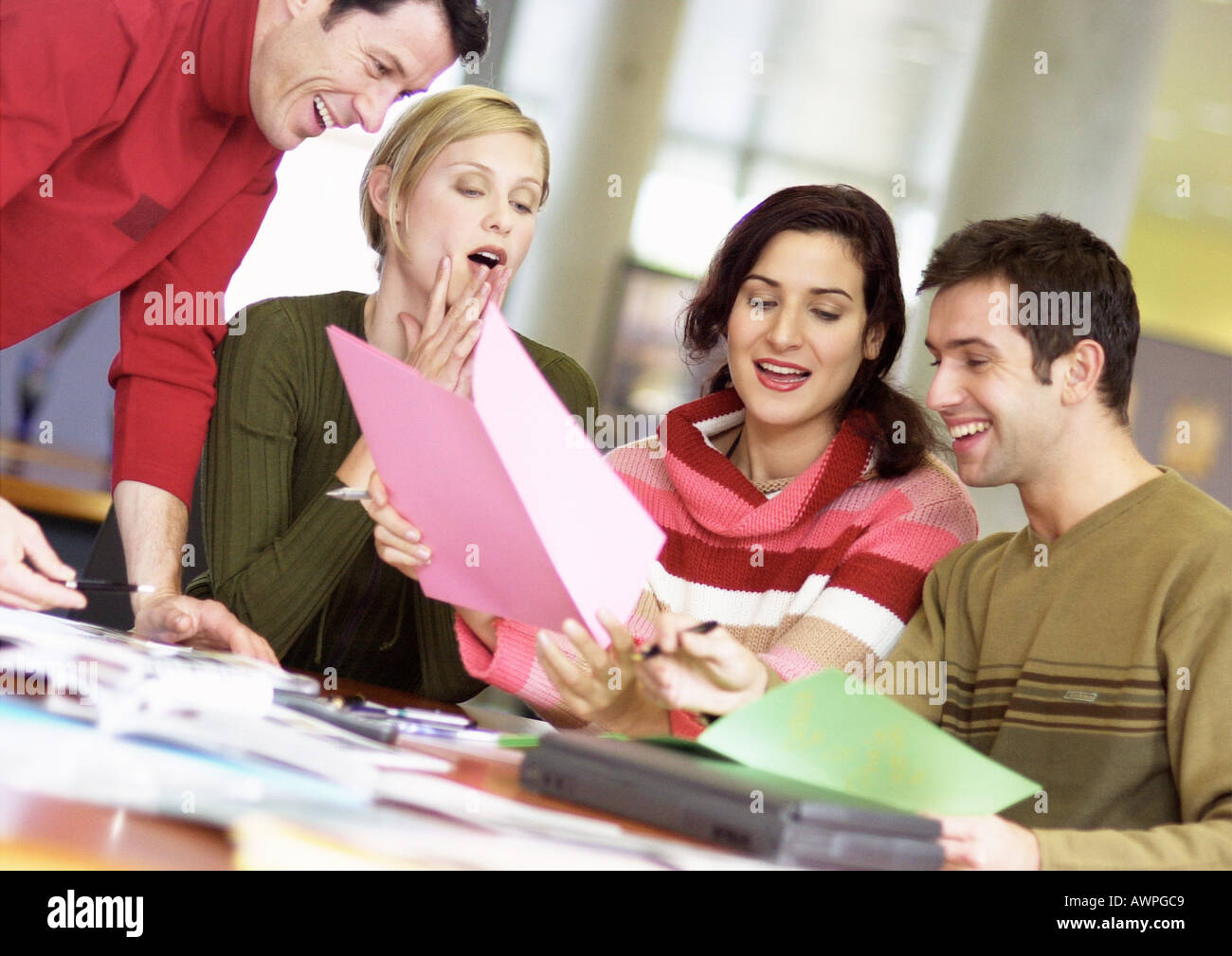 People examining documents, smiling Stock Photo