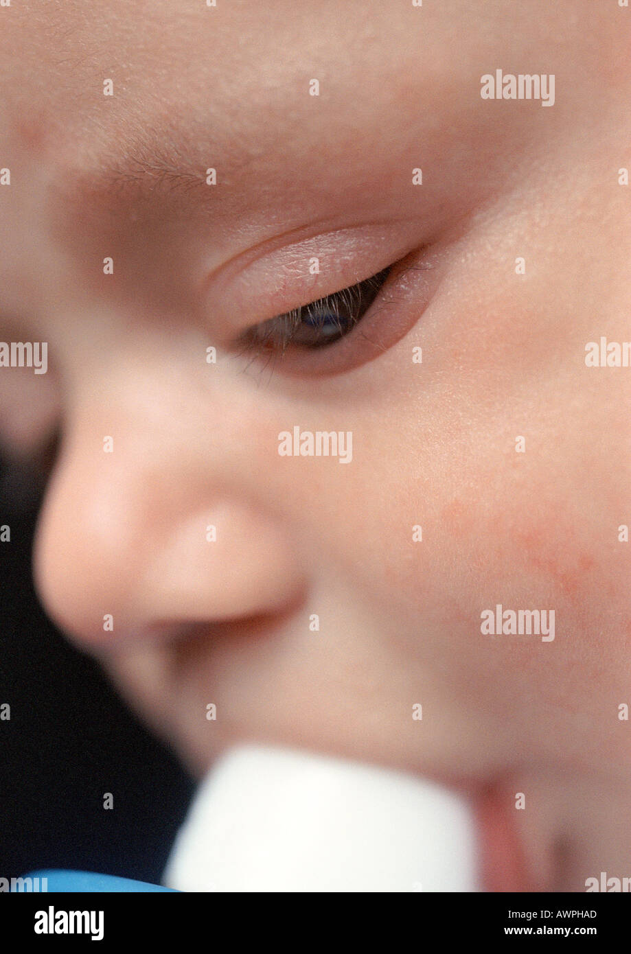 Baby with bottle in mouth, extreme closeup Stock Photo Alamy