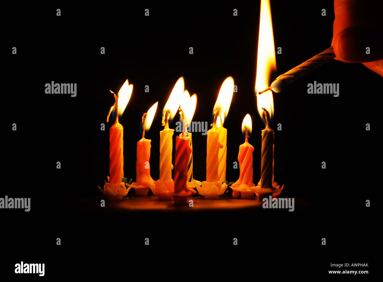 Lighting a candle on a birthday cake Stock Photo Alamy