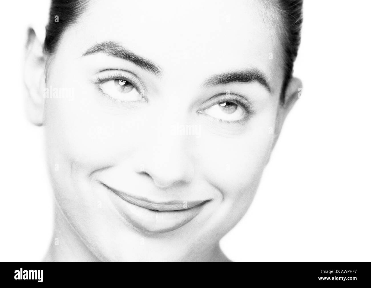 Woman smiling, looking up, close-up, portrait, b&w Stock Photo