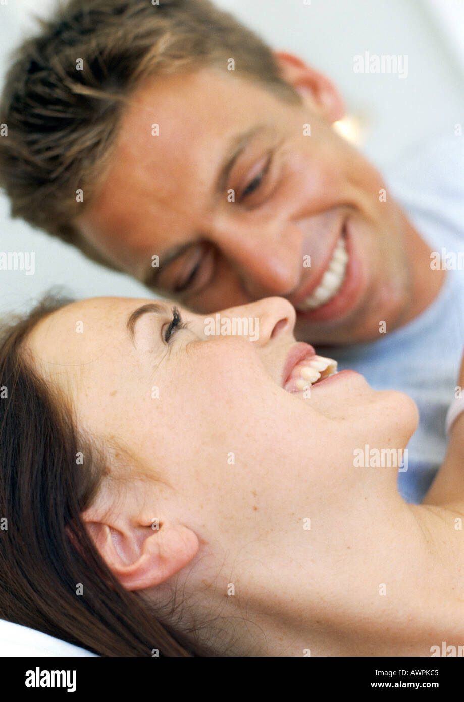 Couple resting in bed smiling, close-up Stock Photo