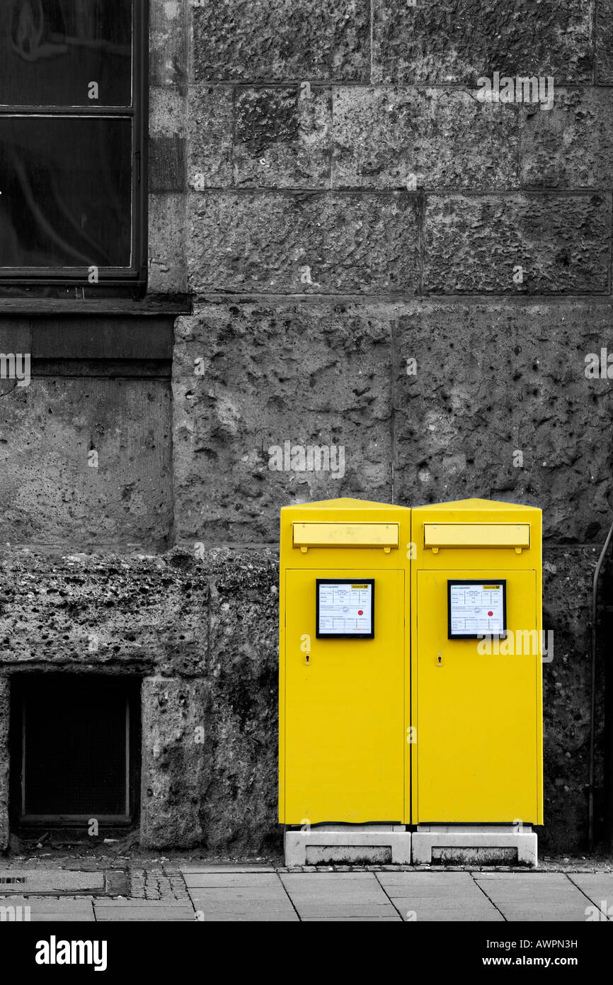 Two yellow mailboxes in front of a grey house wall, Augsburg, Bavaria, Germany, Europe Stock Photo