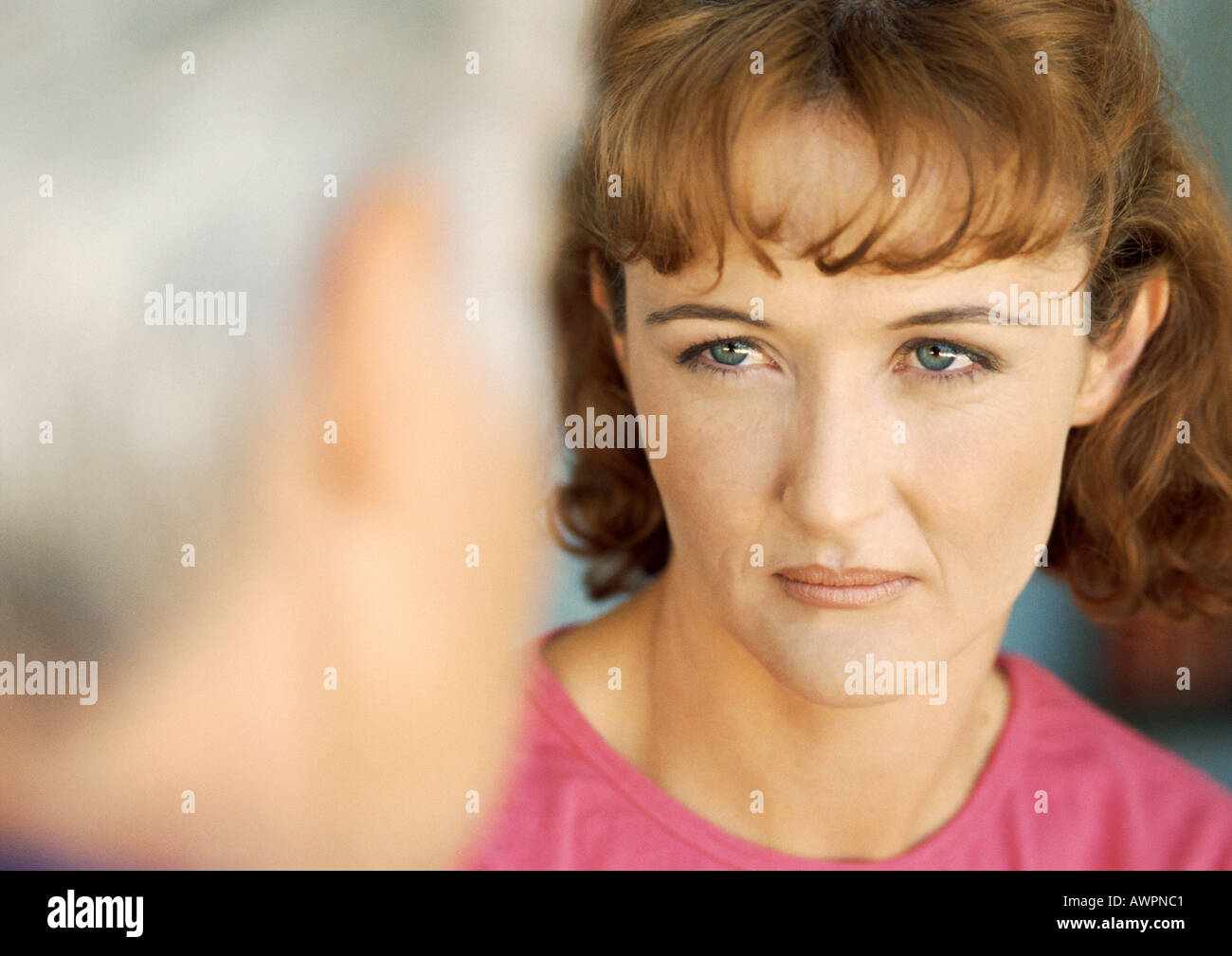 Woman looking at senior woman, close-up, blurred foreground Stock Photo