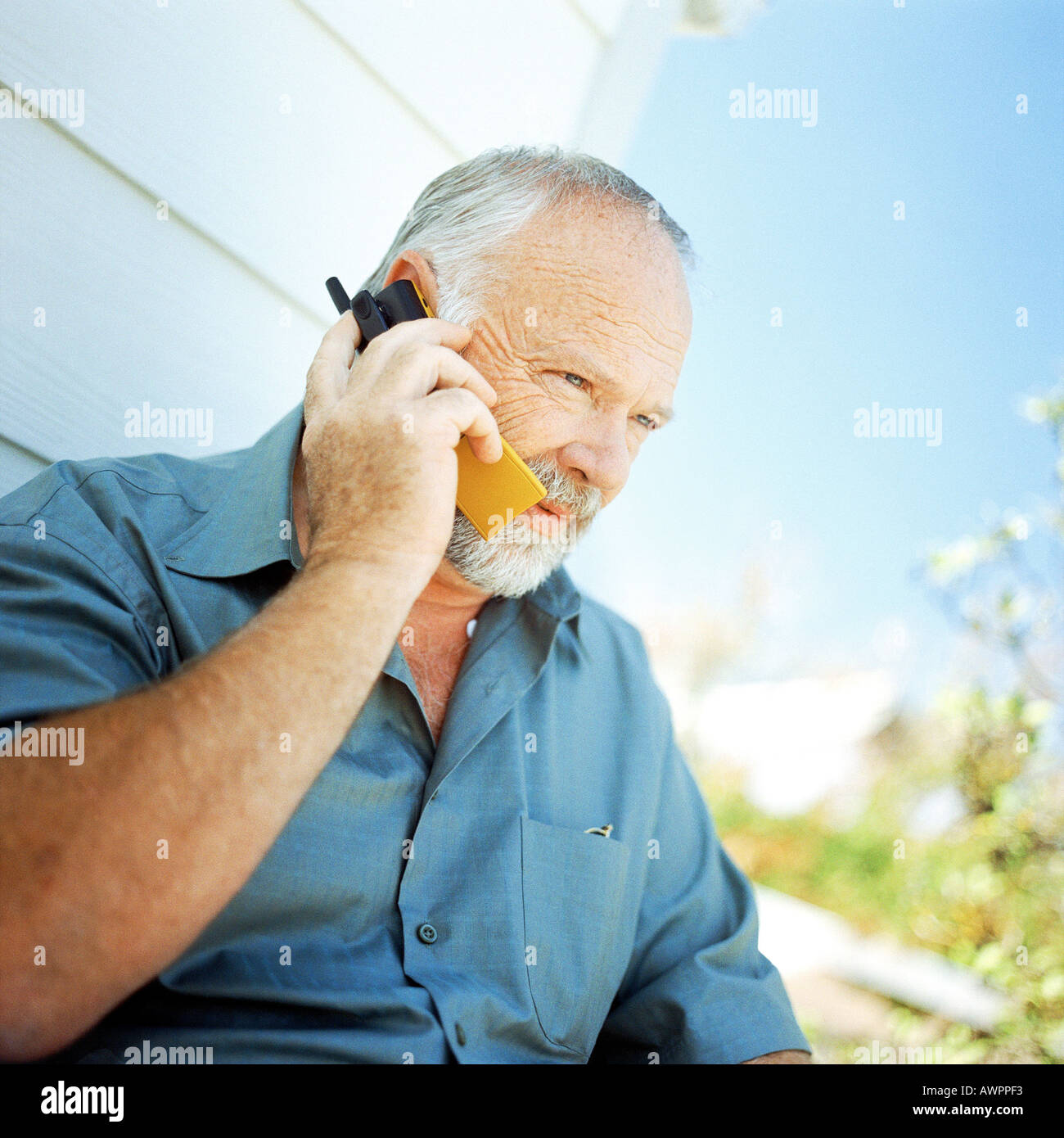 Mature man using cell phone, outside Stock Photo