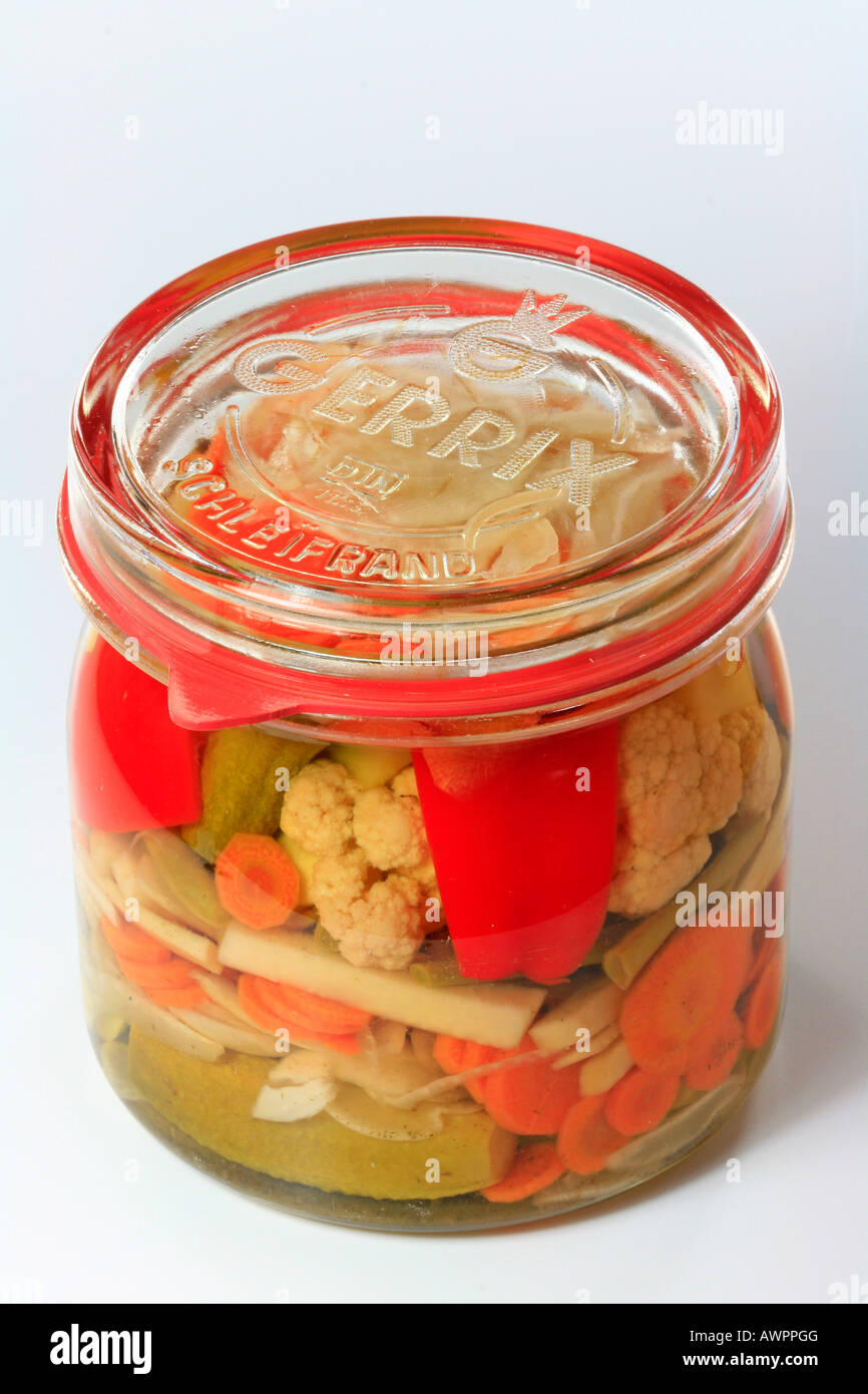 Jar of mixed pickles in a mason jar, pickled cucumbers, carrots, beans, peppers and cauliflower Stock Photo