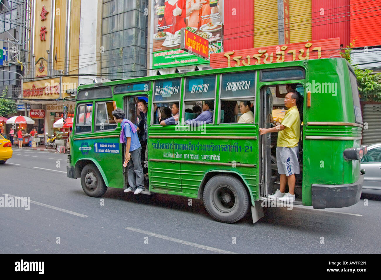 Small, crowded bus in Chinatown, Bangkok, Thailand Stock Photo