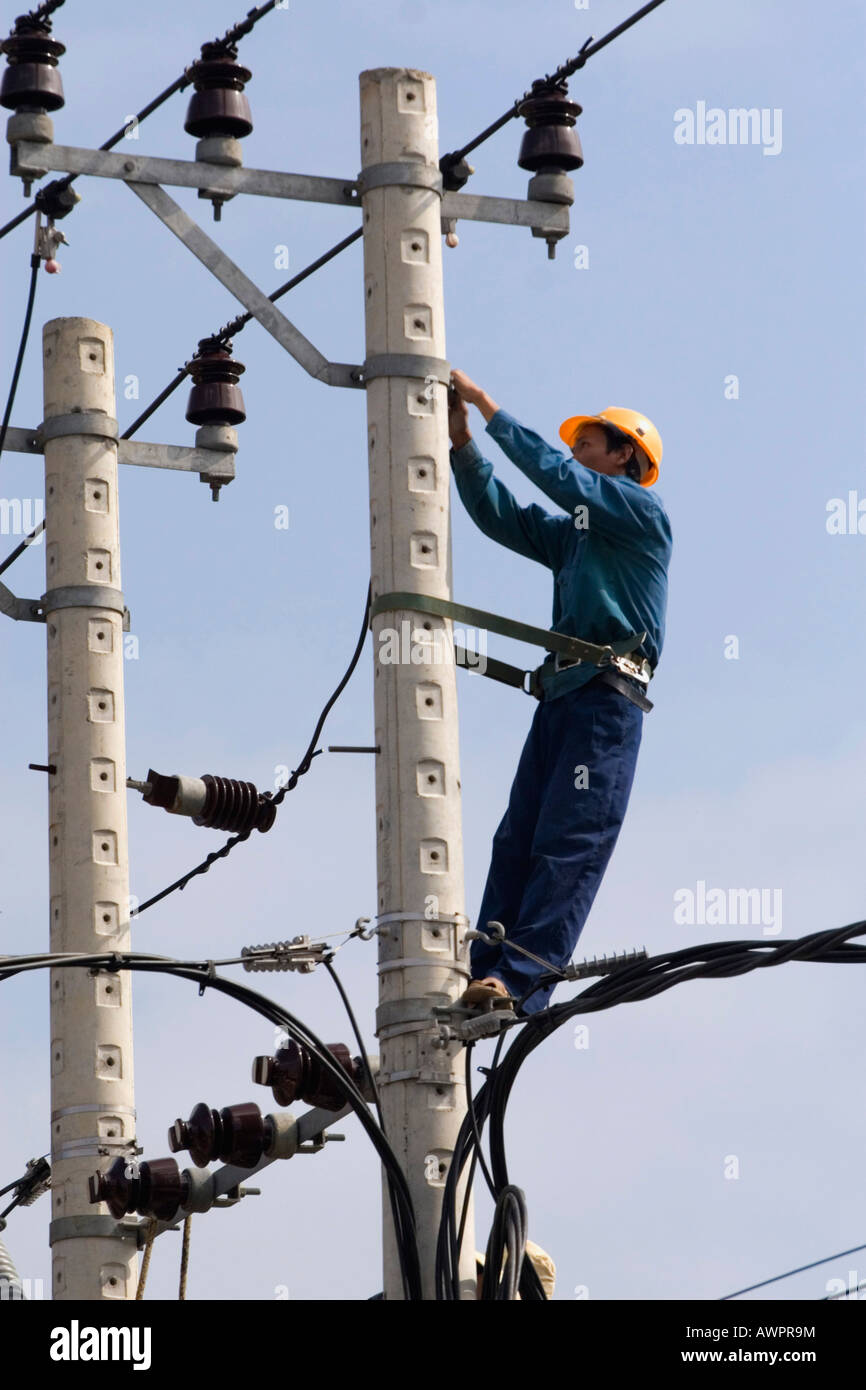 Electrician at work, Vietnam, Asia Stock Photo