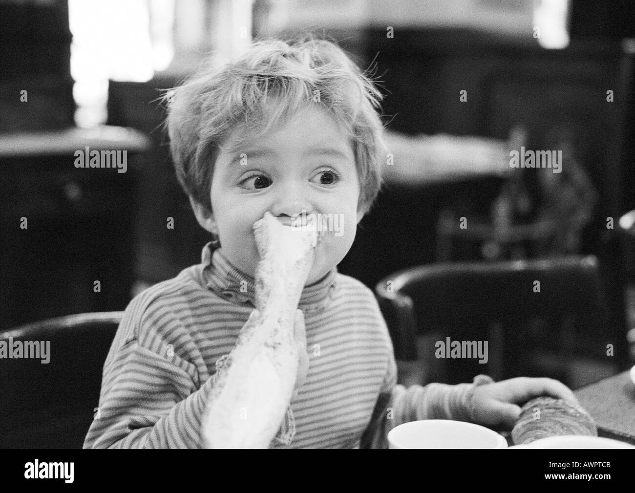 Little girl eating slice bread Black and White Stock Photos & Images ...