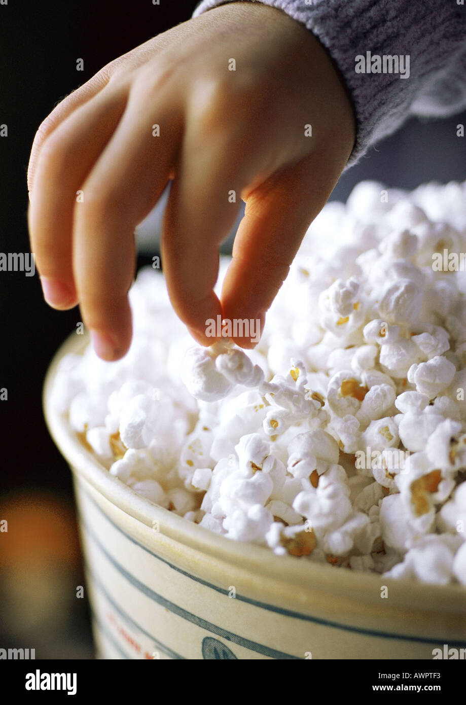 Child eating popcorn, closeup of hand and popcorn Stock Photo Alamy