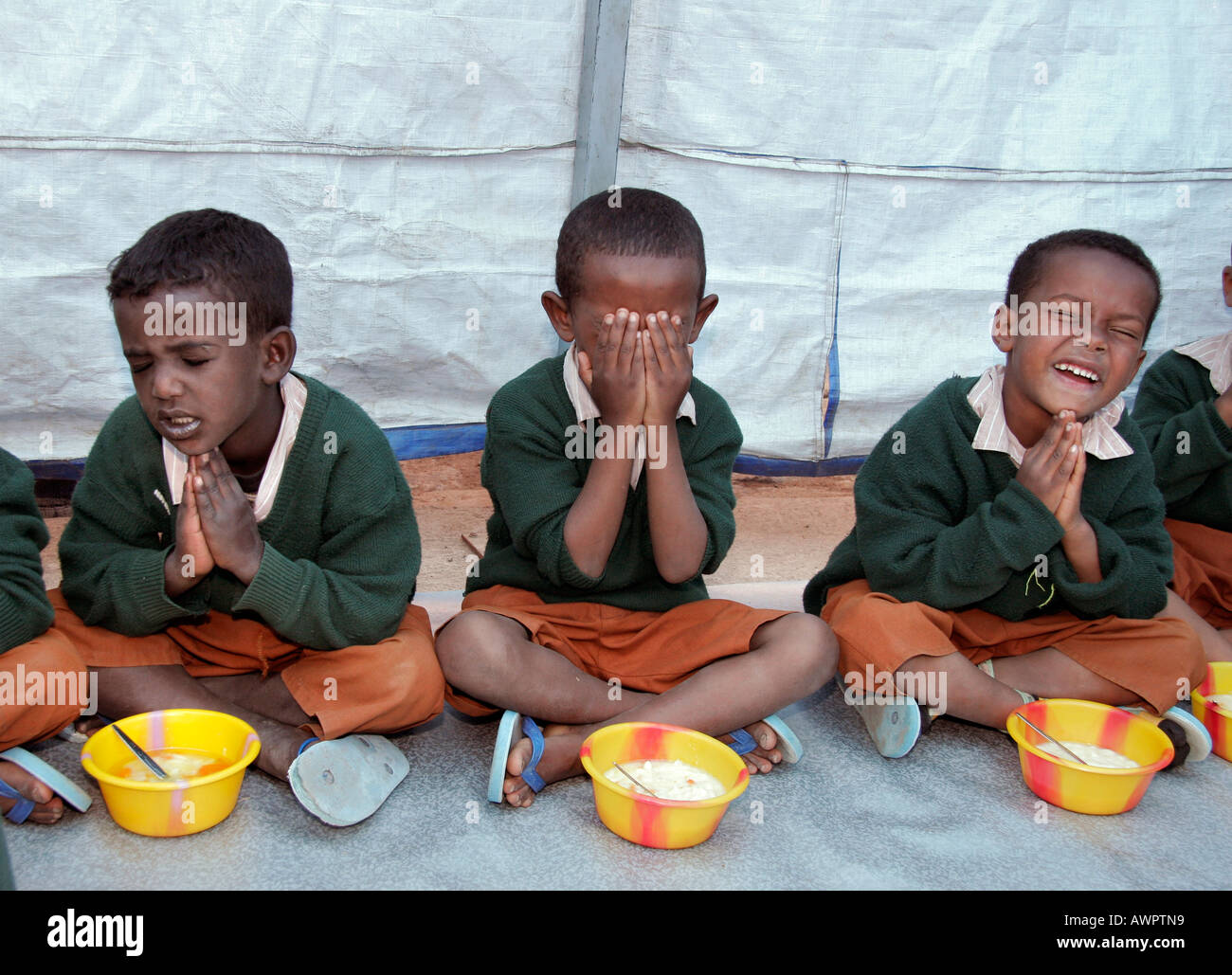 ETHIOPIA Children praying and eating lunch at the Bethlehem Centre pre school and day care Addis Ababa photo by Sean Sprague Stock Photo