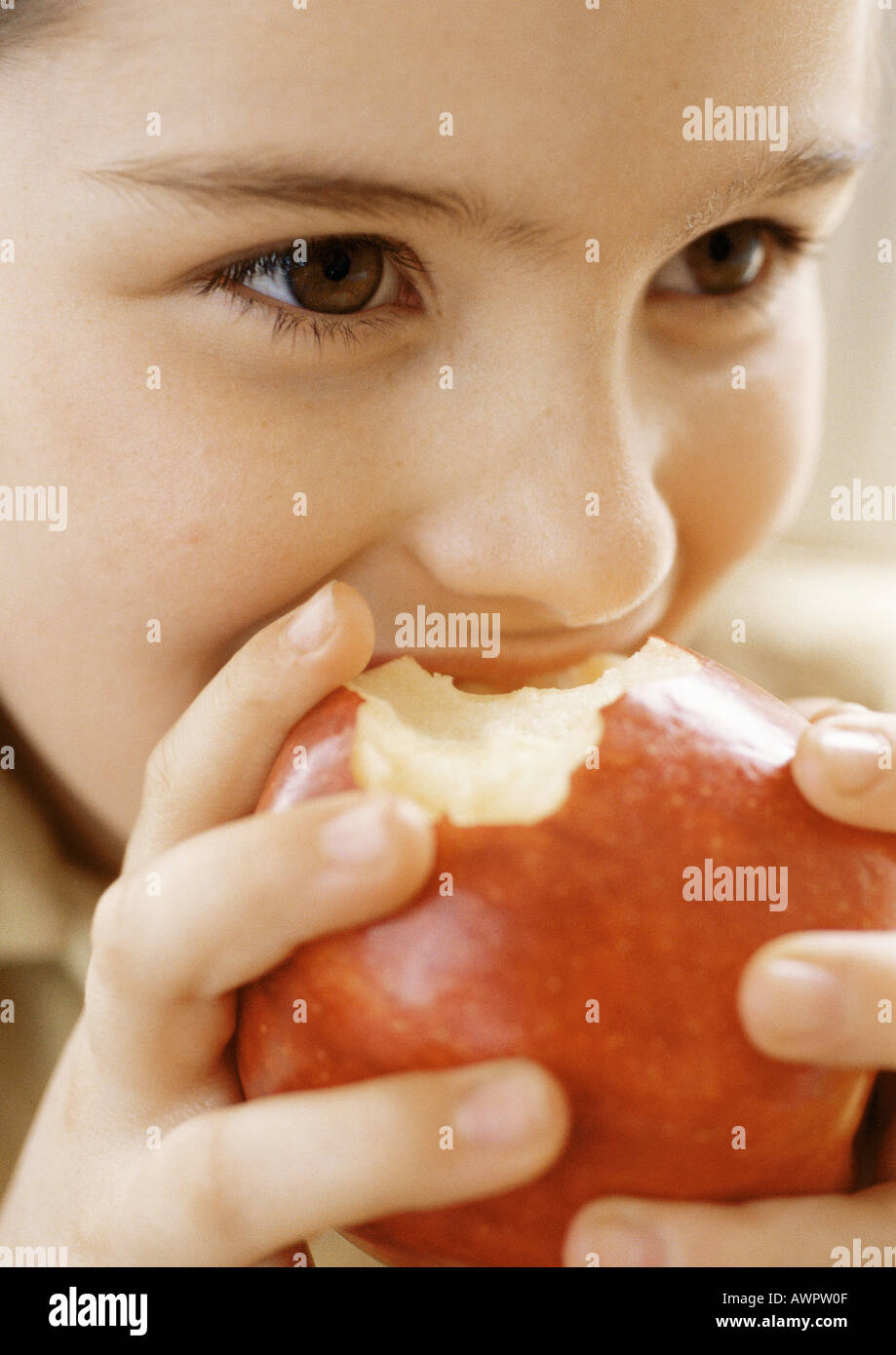 Child eating apple, close up Stock Photo Alamy