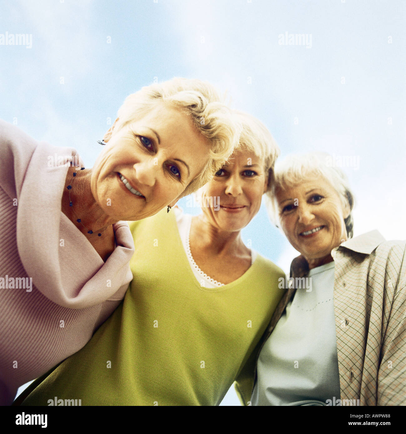 Three mature women, looking at camera, low angle view Stock Photo