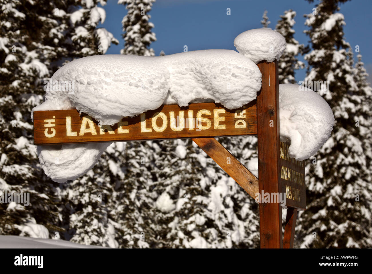 Snow packed on Lake Louise Drive sign Stock Photo