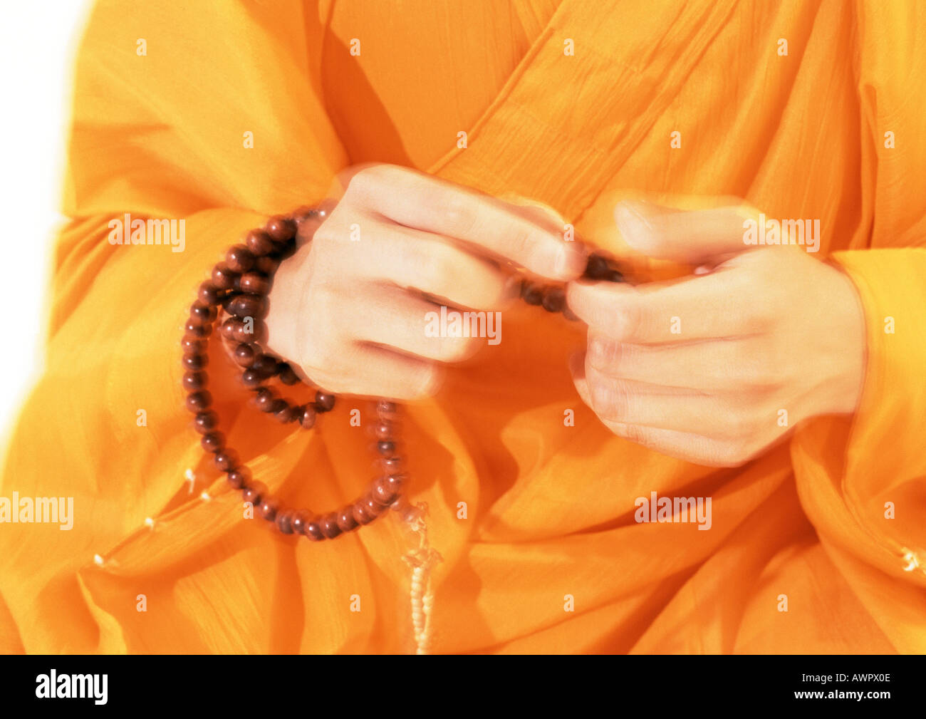 Buddhist monk's hands holding prayer beads Stock Photo - Alamy