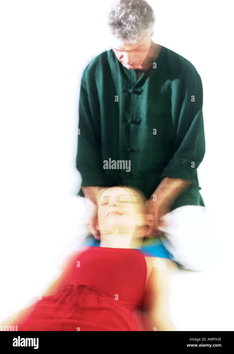 Massage therapist massaging woman's head, blurred Stock Photo