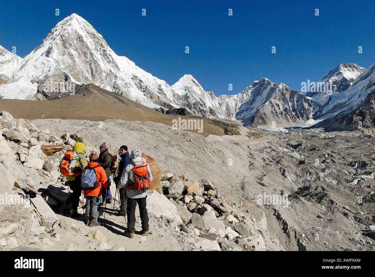 Trekking group on Khumbu glacier with Pumori (7161), Khumbu Himal, Sagarmatha National Park, Nepal Stock Photo