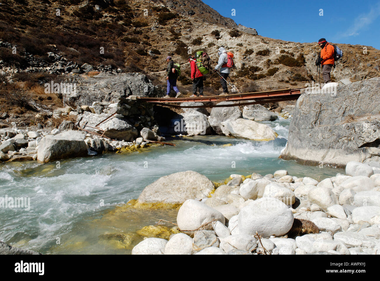 Trekking group on a bridge at Lobuche Khola valley, Sagarmatha National Park, Khumbu Himal, Nepal Stock Photo