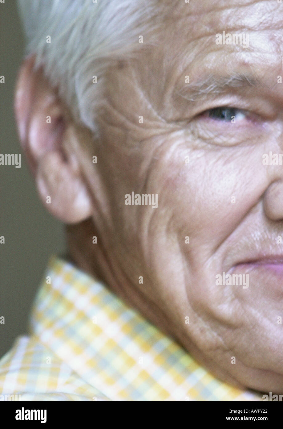 Senior man looking into camera, partial view, close-up. Stock Photo