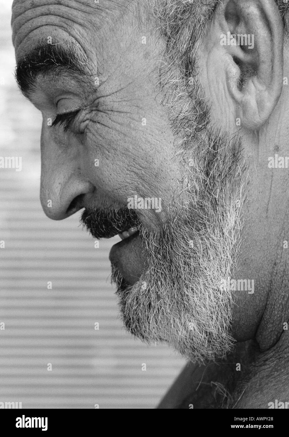 Mature man smiling, side view, close-up, b&w. Stock Photo