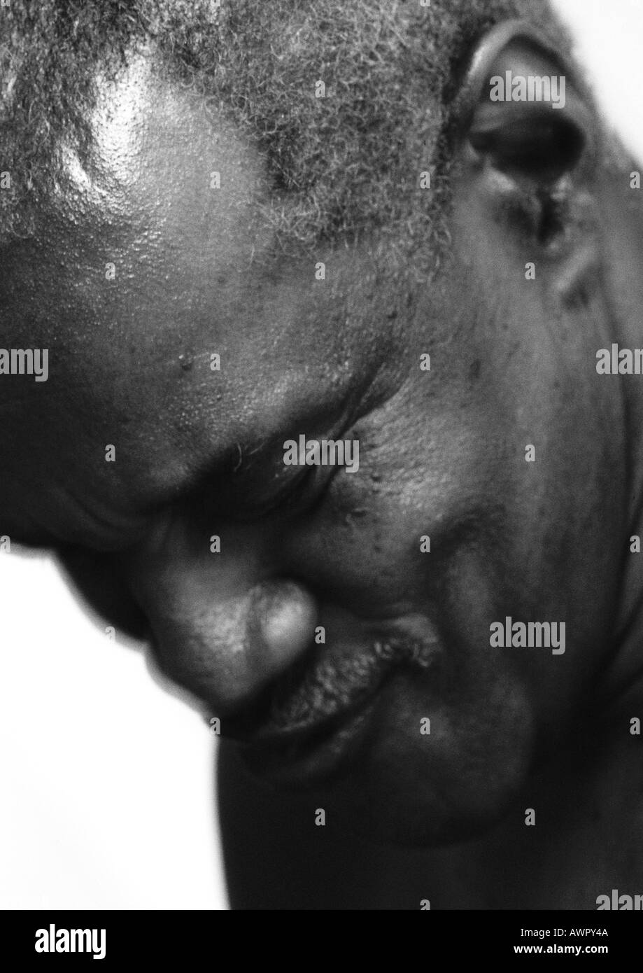 Senior man smiling, head down, close-up. Stock Photo