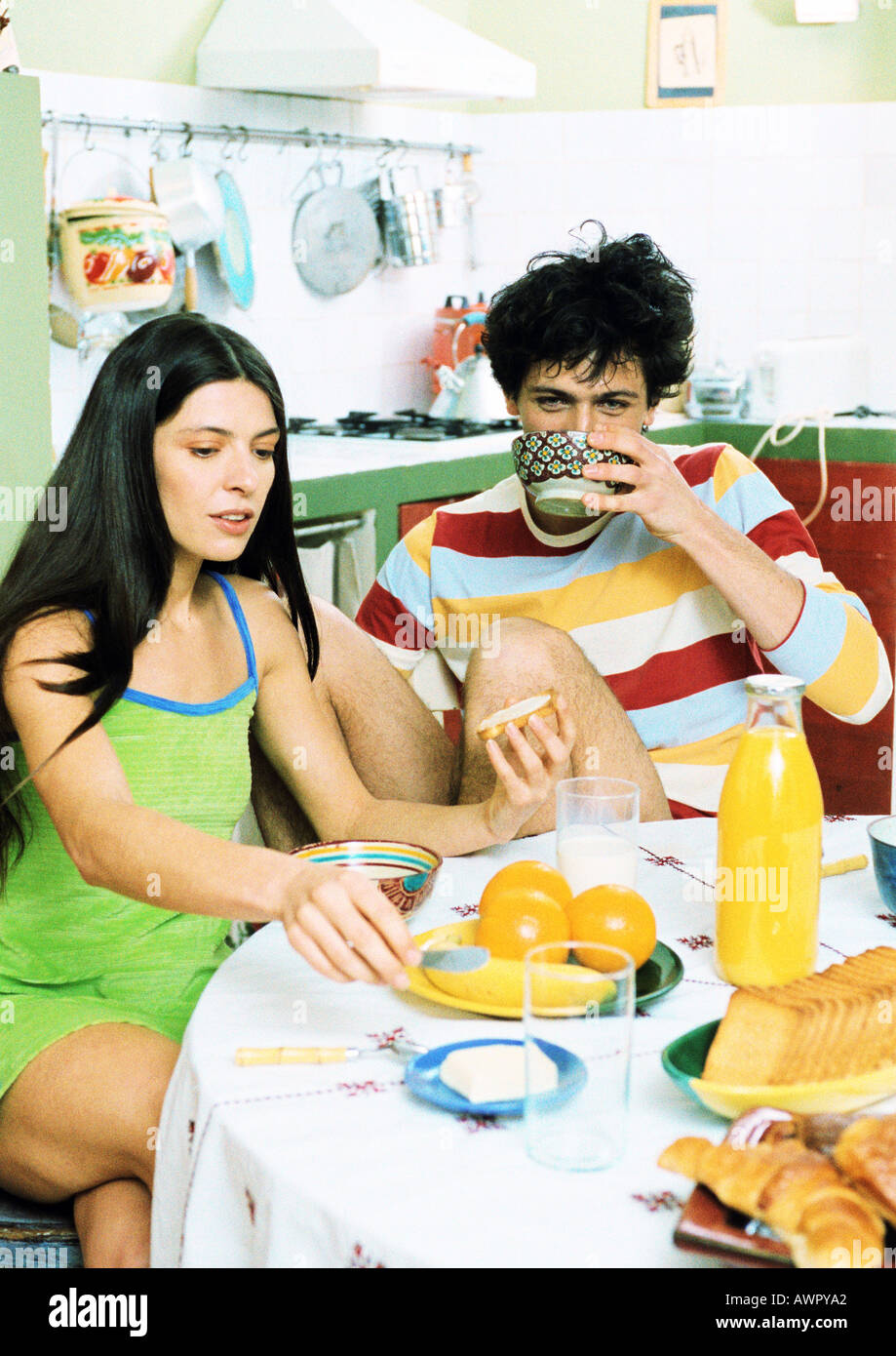Young couple sitting at table having breakfast. Stock Photo