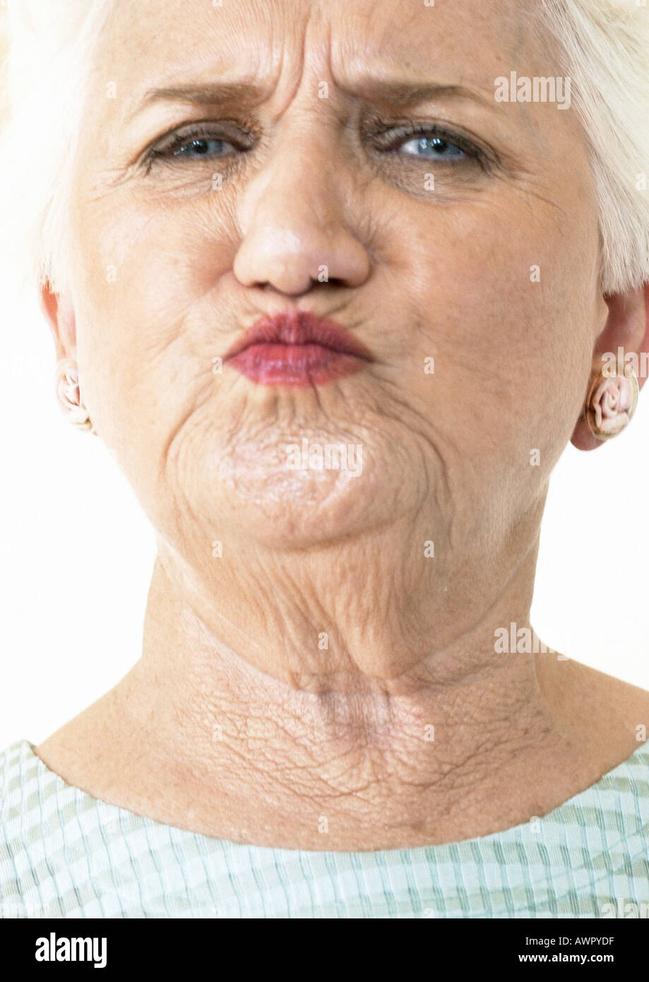 Elderly woman puckering lips and looking at camera, portrait, close-up Stock Photo