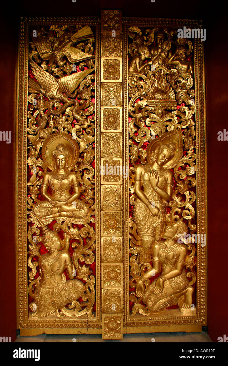 Laos Luang Prabang Wat Haw Pha Bang carved gilded wooden door Stock Photo
