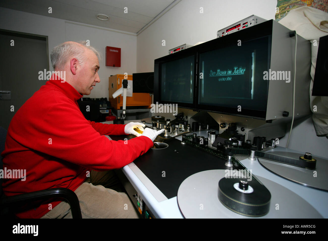 Film conservator looking at the cutting tabe in the Bundesarchiv Koblenz Rhineland-Palatinate Germany. Stock Photo