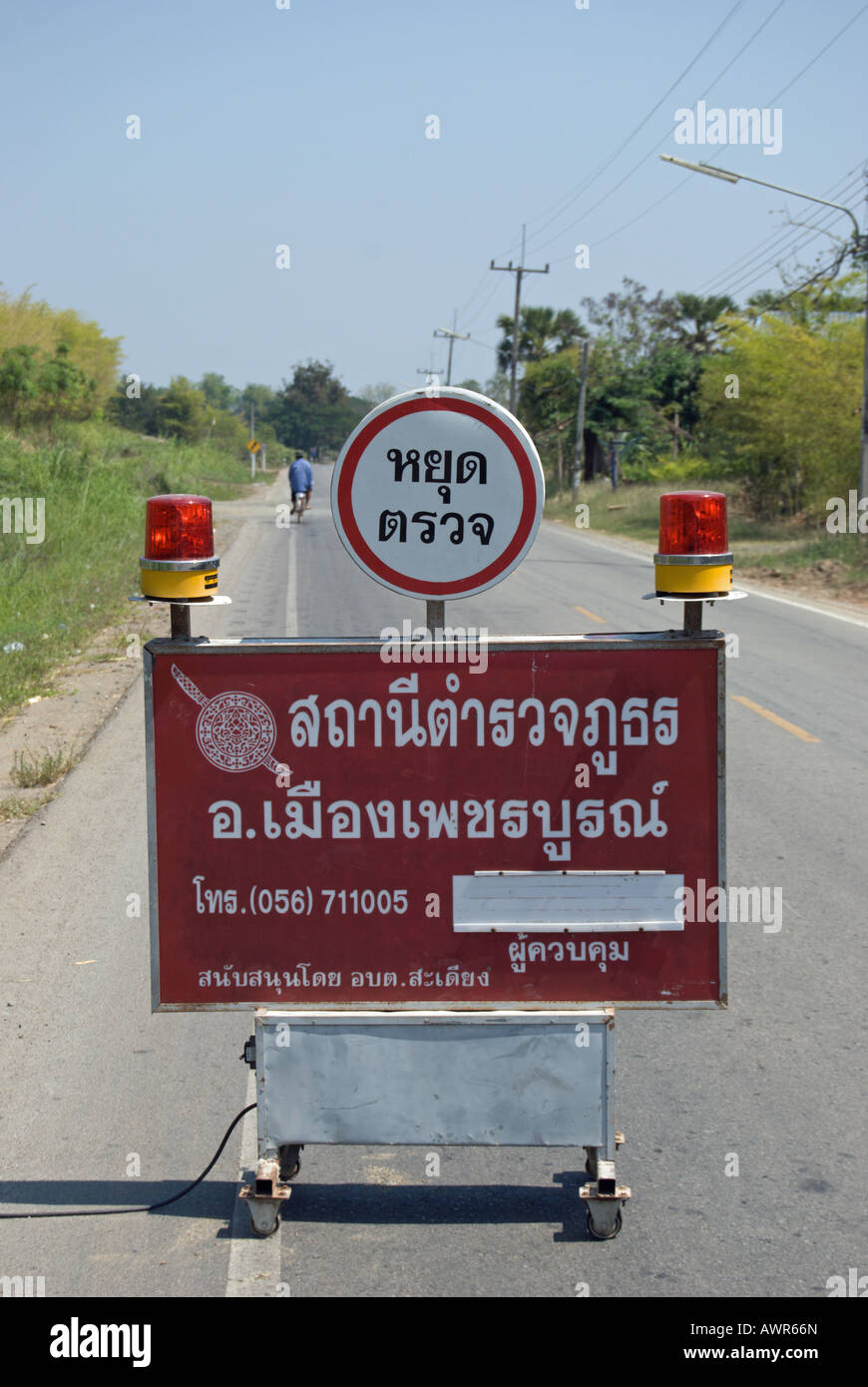 road sign near phetchabun, thailand, advising road users of a police checkpoint Stock Photo