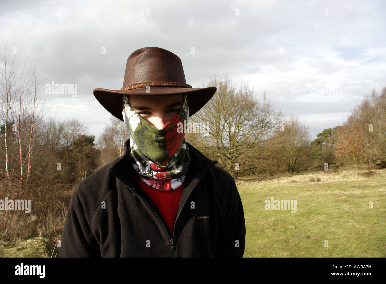 Teenage boy wearing a buff and a leather hat Stock Photo - Alamy