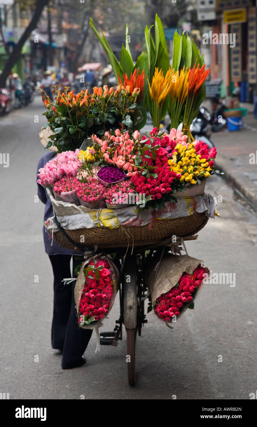 A flower merchant uses a bicycle as a mobile store HANOI VIETNAM Stock Photo