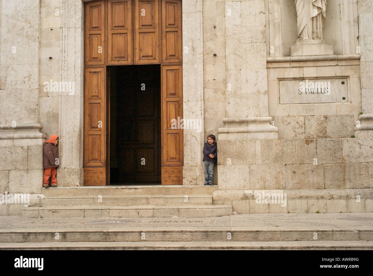 Church with kids playing italy abruzzo Stock Photo