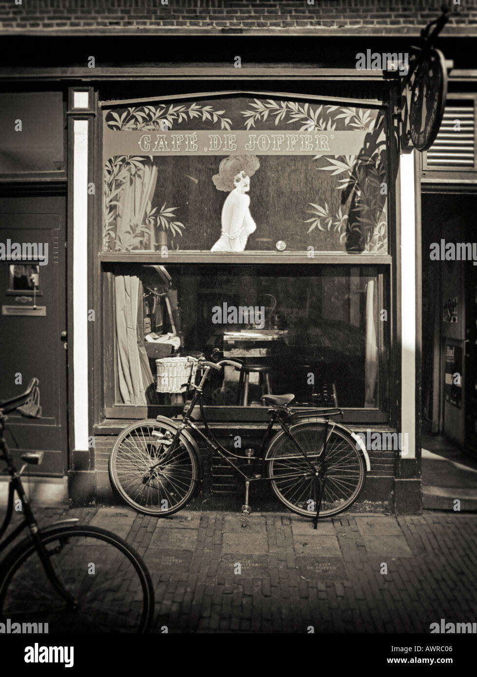 Black and white photography - Bicycle parked outside a traditional Dutch Street Cafe Amsterdam the Netherlands Stock Photo