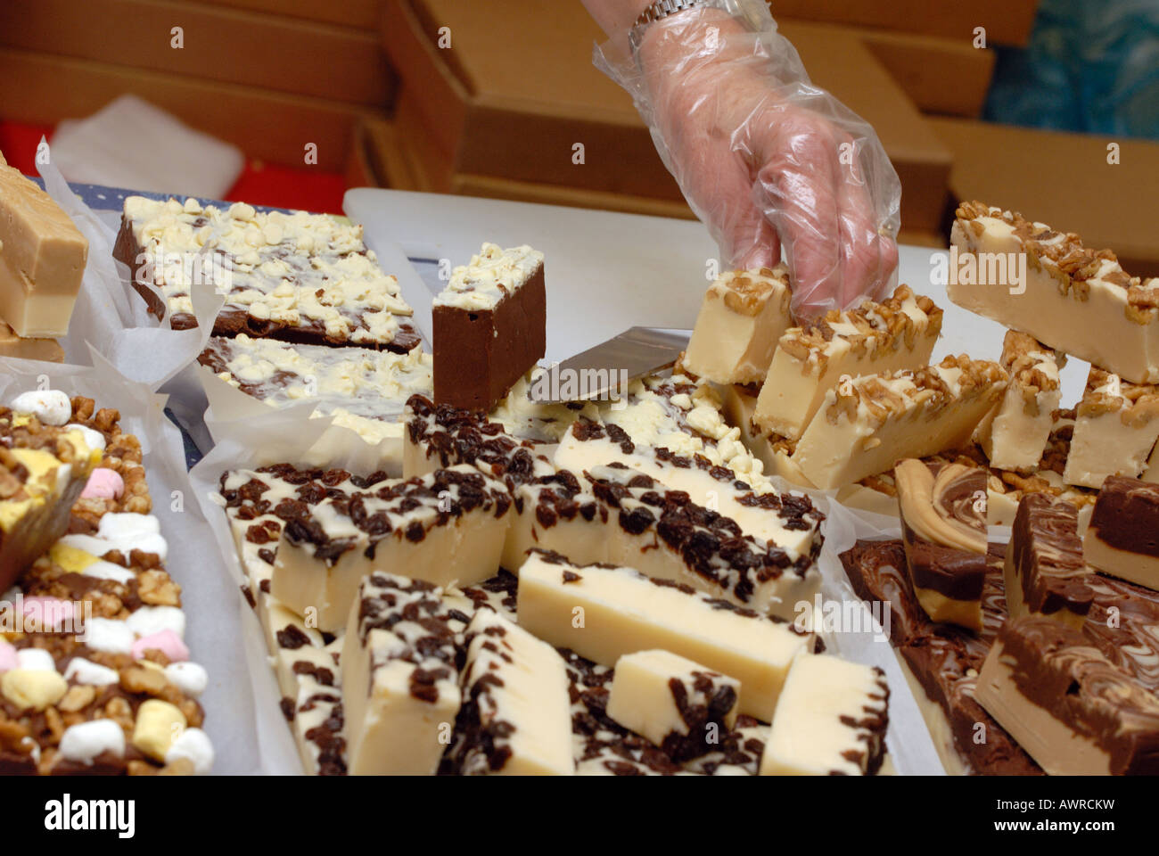 a person serving a selection of hand homemade confections confectionary at a farmers market fudge local fayre fete isle of wight Stock Photo