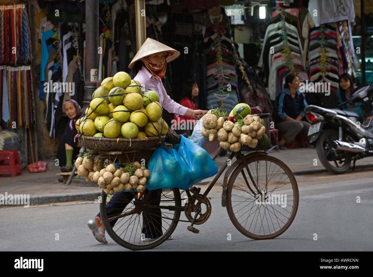A mobile fruit and vegetable merchant transports his product via bicycle HANOI VIETNAM Stock Photo