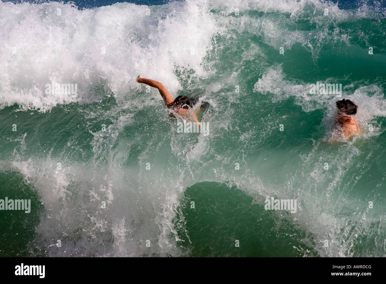 Two Swimmers Wiped Out by a Big Wave Stock Photo