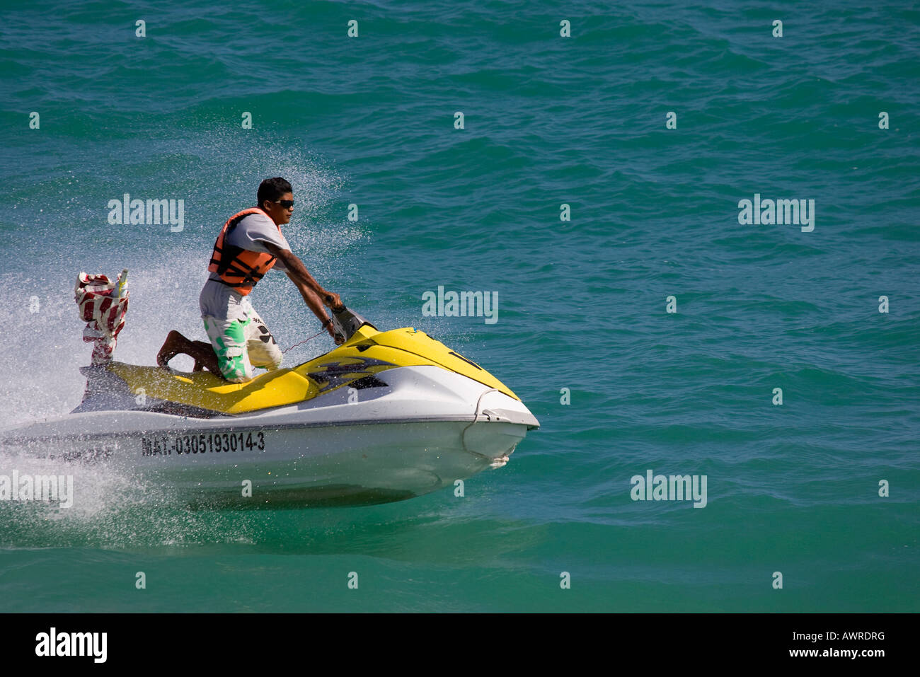 Young Man Riding Jet Ski on his Knees Stock Photo Alamy
