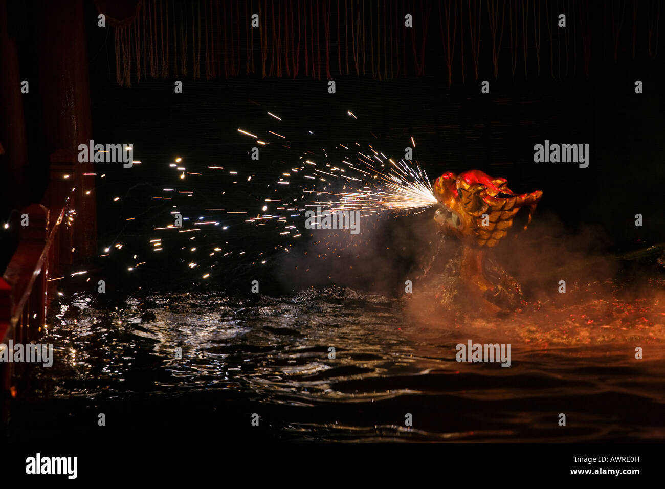 A dragon spews fire inside the THANG LONG MUNICIPAL WATER PUPPET