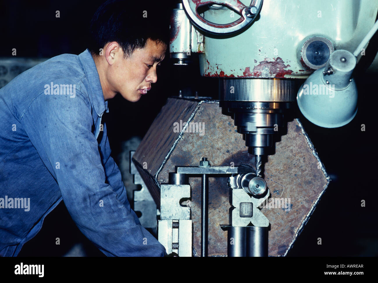 1979 machine shop worker on drill press at Qinghua University in Beijing Stock Photo