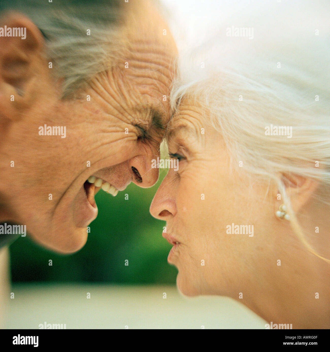 Senior couple arguing, foreheads touching, close-up Stock Photo