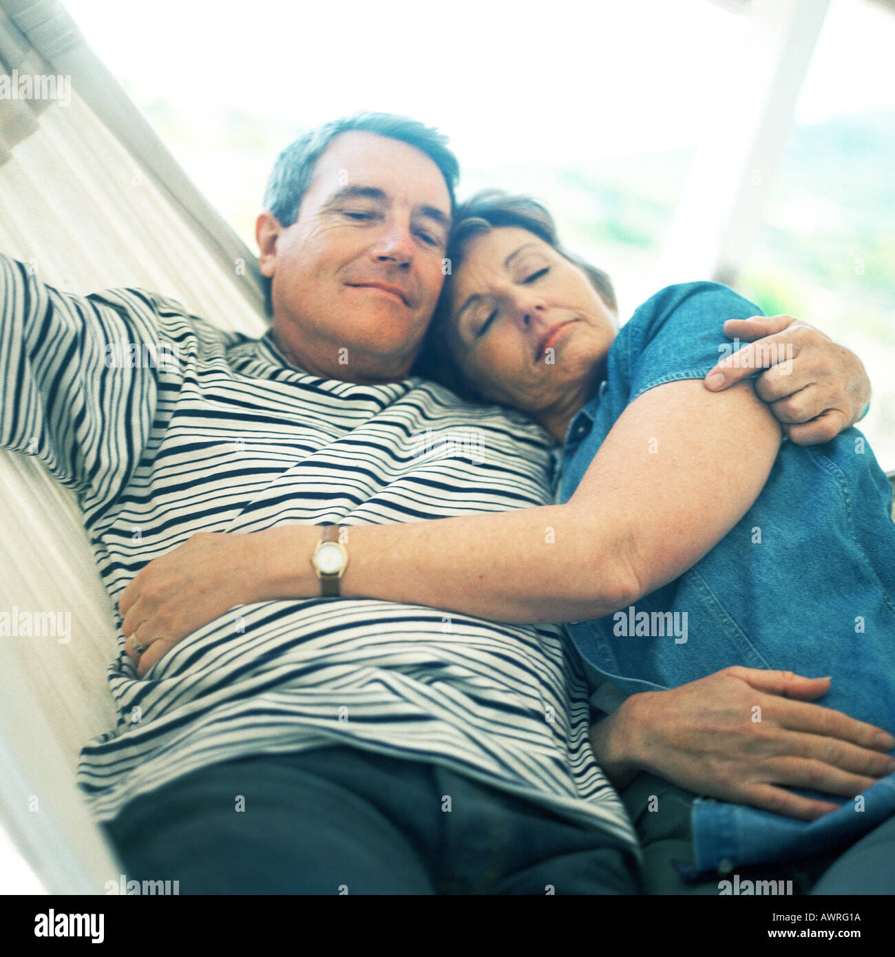 Mature couple lying in hammock Stock Photo