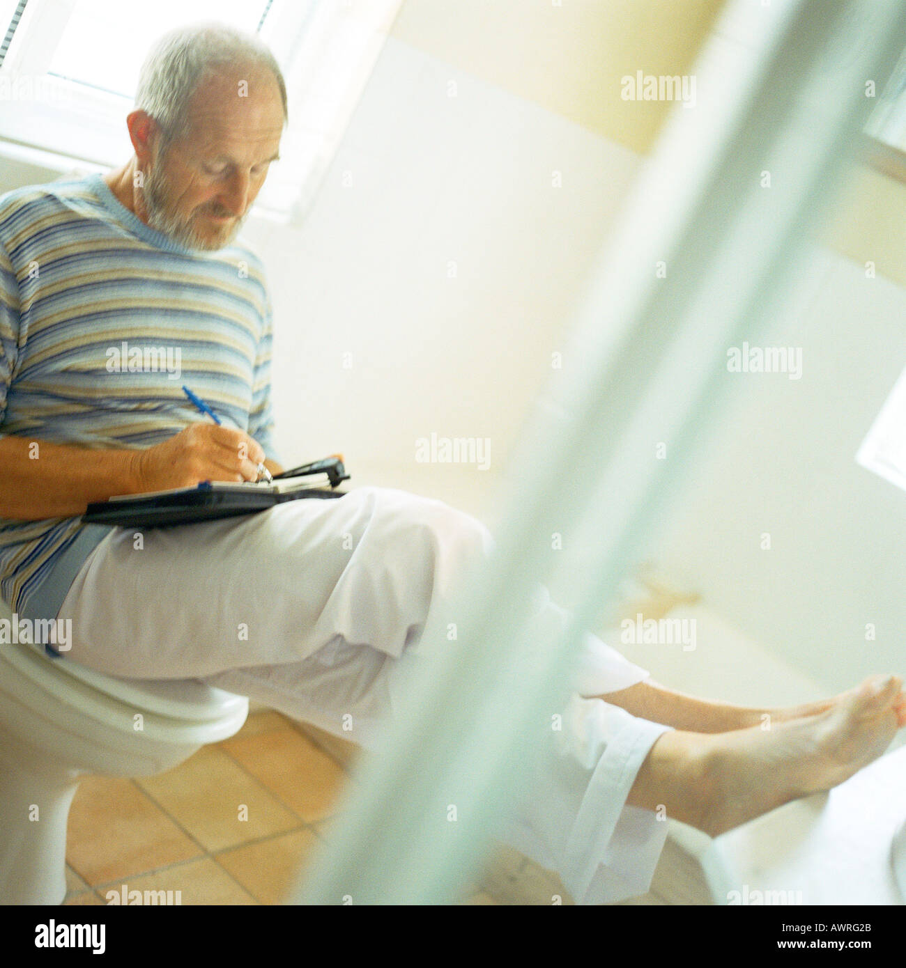 Senior man sitting on toilet hires stock photography and images Alamy