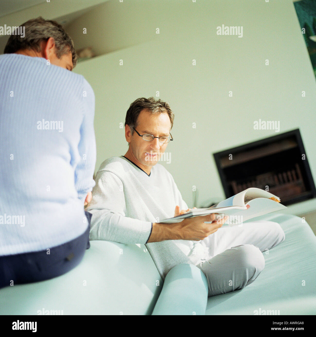 Two men sitting on sofa hi-res stock photography and images - Alamy