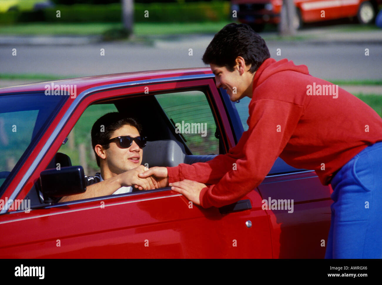 Mexican-American, Salvadorian-American, teens, teen boys, teenage boys, teenagers, good friends, greeting, shaking hands, San Francisco, California Stock Photo