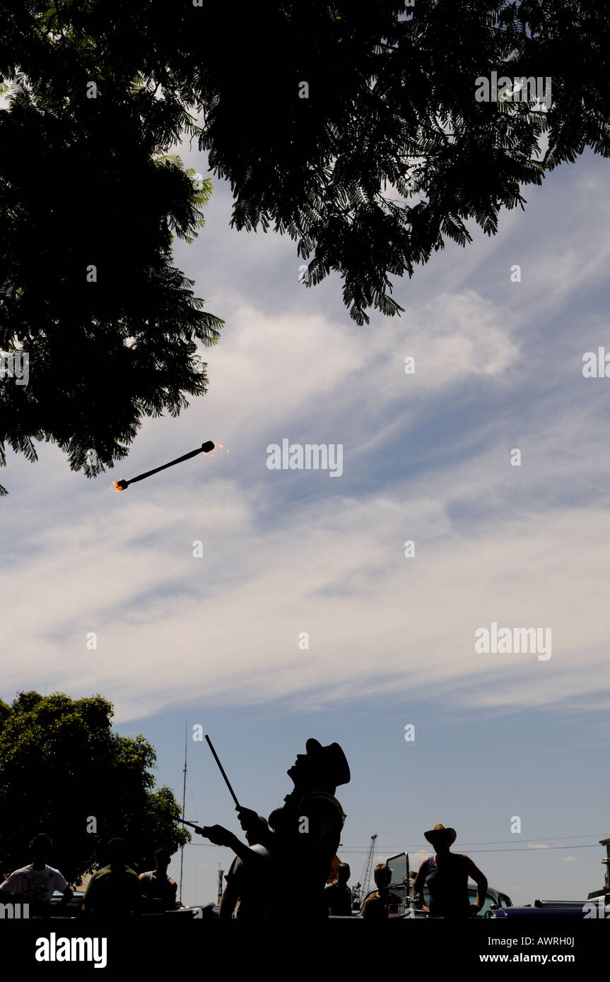 A street performer juggling fire sticks Stock Photo Alamy